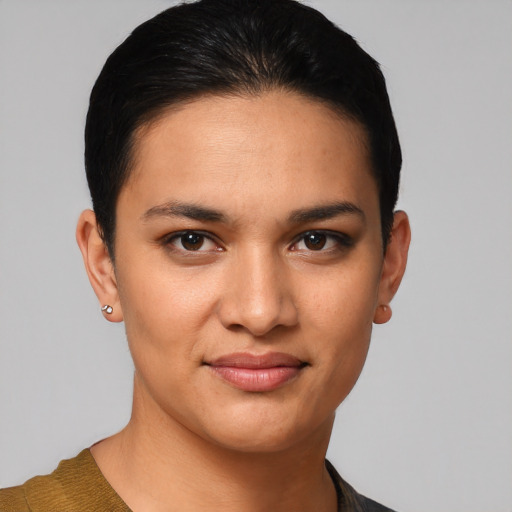 Joyful latino young-adult female with short  black hair and brown eyes