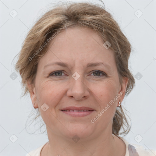 Joyful white adult female with medium  brown hair and grey eyes