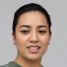 Joyful asian young-adult female with short  brown hair and brown eyes