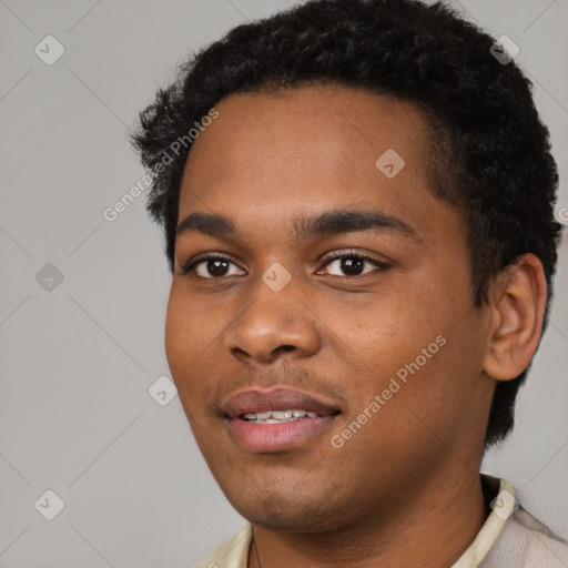 Joyful black young-adult male with short  black hair and brown eyes