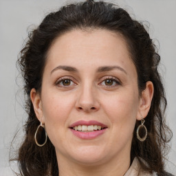 Joyful white adult female with long  brown hair and brown eyes