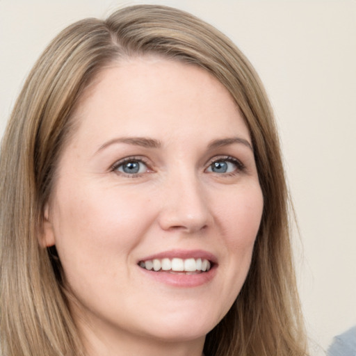 Joyful white young-adult female with long  brown hair and grey eyes