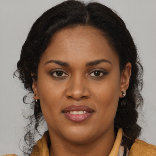Joyful black young-adult female with medium  brown hair and brown eyes