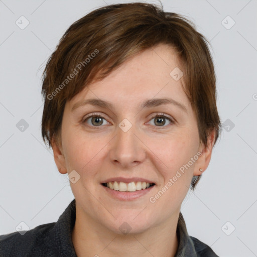 Joyful white young-adult female with short  brown hair and grey eyes