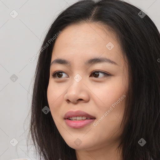 Joyful asian young-adult female with long  brown hair and brown eyes