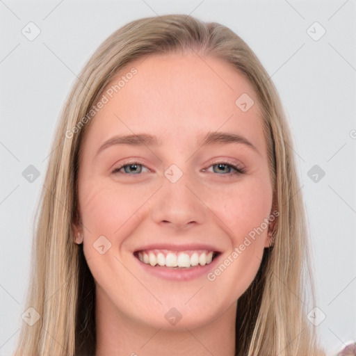 Joyful white young-adult female with long  brown hair and blue eyes