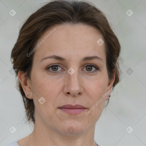 Joyful white adult female with medium  brown hair and green eyes