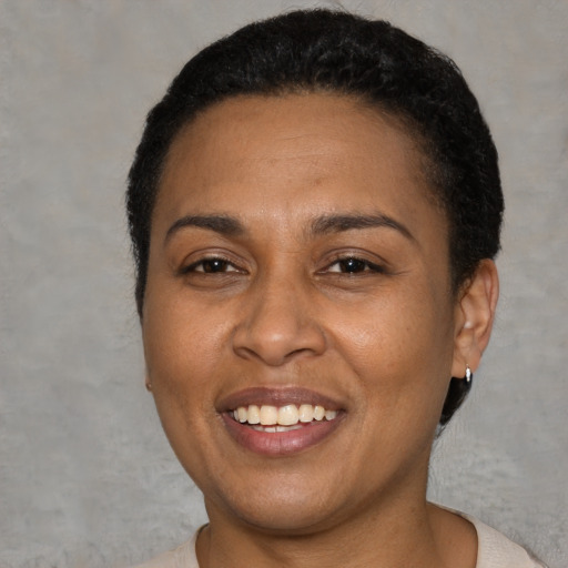 Joyful latino young-adult female with short  black hair and brown eyes