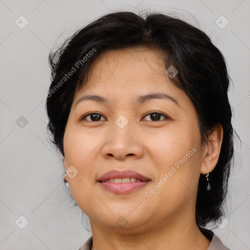 Joyful asian adult female with medium  brown hair and brown eyes