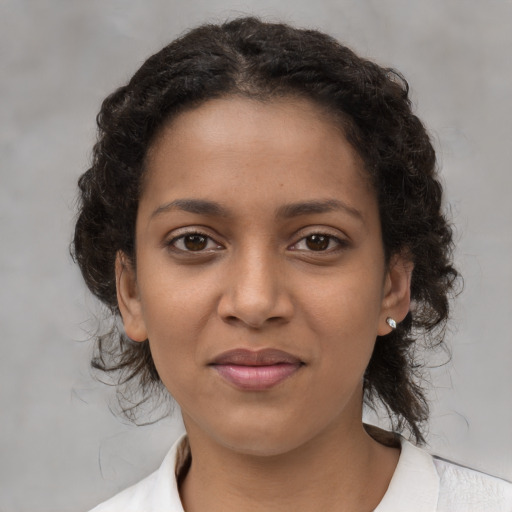 Joyful black young-adult female with medium  brown hair and brown eyes