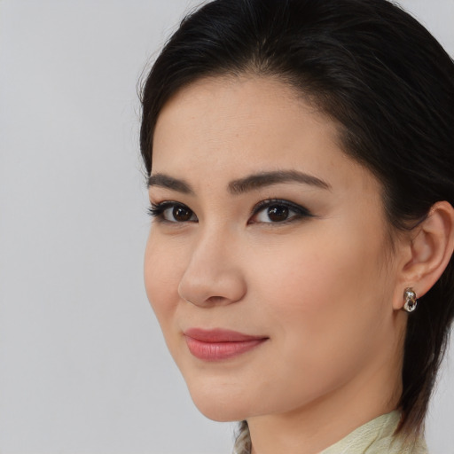 Joyful asian young-adult female with medium  brown hair and brown eyes