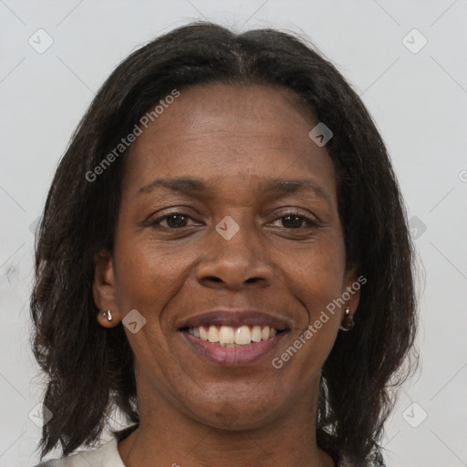 Joyful black adult female with medium  brown hair and brown eyes