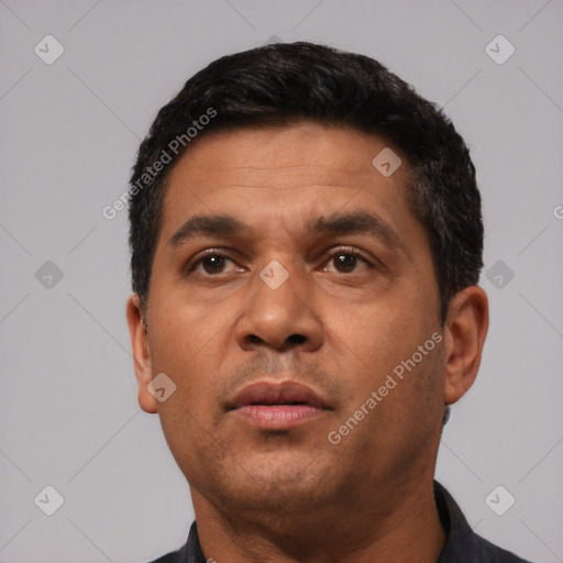 Neutral latino adult male with short  black hair and brown eyes