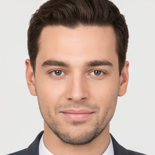 Joyful white young-adult male with short  brown hair and brown eyes