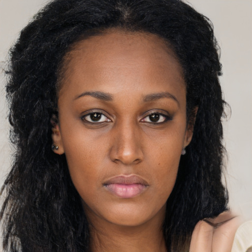 Neutral black young-adult female with long  brown hair and brown eyes