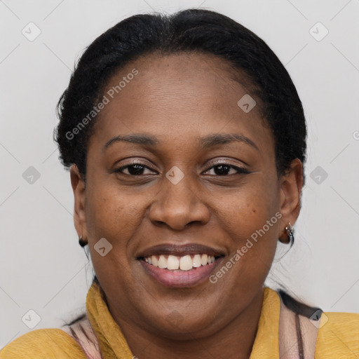 Joyful black adult female with short  brown hair and brown eyes