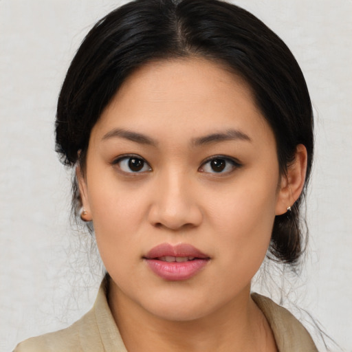 Joyful latino young-adult female with medium  black hair and brown eyes