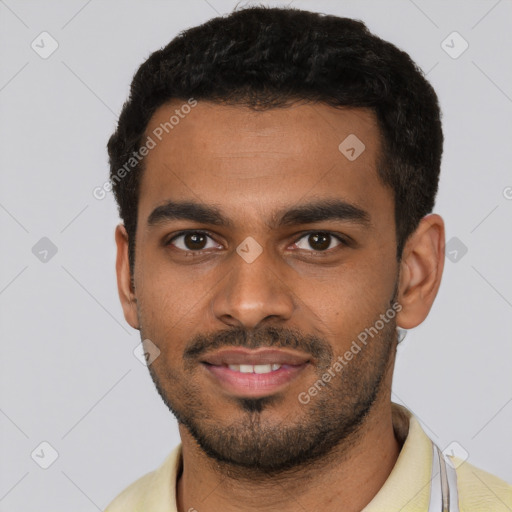Joyful black young-adult male with short  black hair and brown eyes