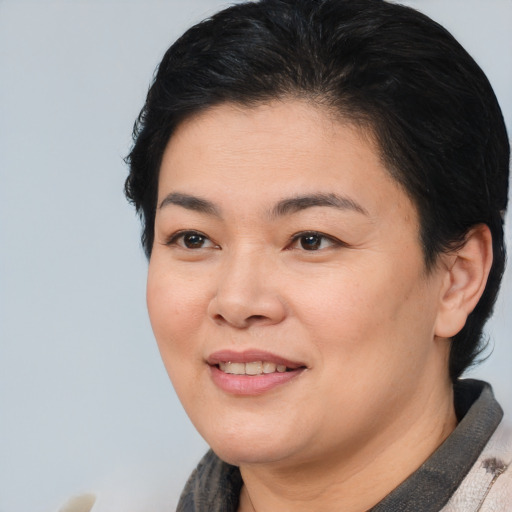 Joyful white young-adult female with short  black hair and brown eyes