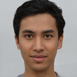 Joyful latino young-adult male with short  brown hair and brown eyes