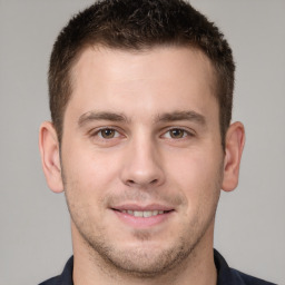 Joyful white young-adult male with short  brown hair and brown eyes