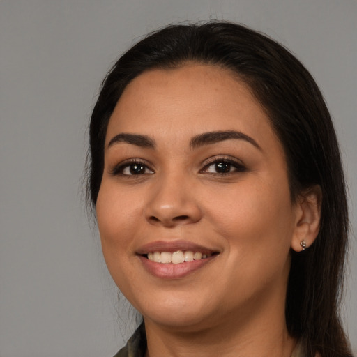 Joyful latino young-adult female with long  brown hair and brown eyes