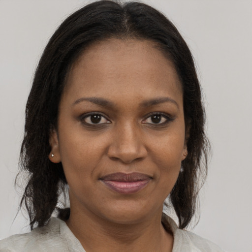 Joyful black young-adult female with medium  brown hair and brown eyes