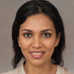 Joyful black young-adult female with medium  brown hair and brown eyes