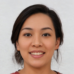 Joyful asian young-adult female with medium  black hair and brown eyes