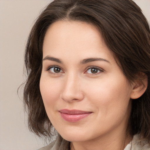 Joyful white young-adult female with medium  brown hair and brown eyes