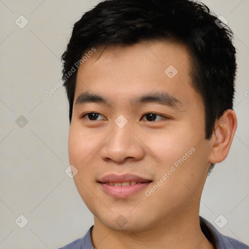 Joyful asian young-adult male with short  black hair and brown eyes