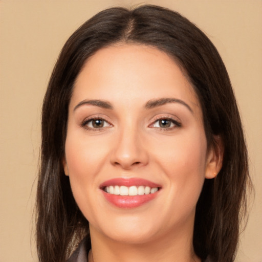 Joyful white young-adult female with long  brown hair and brown eyes