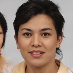 Joyful asian young-adult female with medium  brown hair and brown eyes