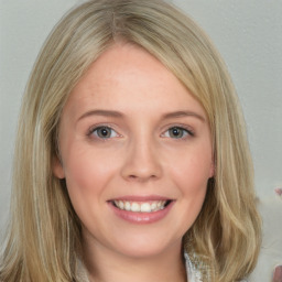 Joyful white young-adult female with medium  brown hair and blue eyes