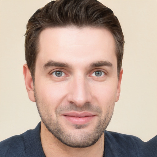 Joyful white young-adult male with short  brown hair and grey eyes