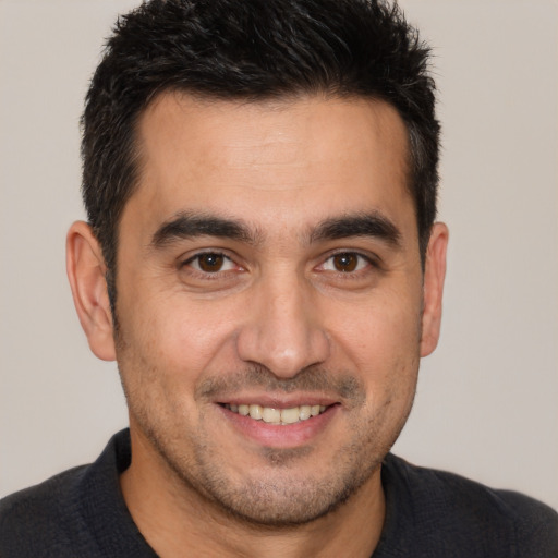 Joyful white adult male with short  brown hair and brown eyes