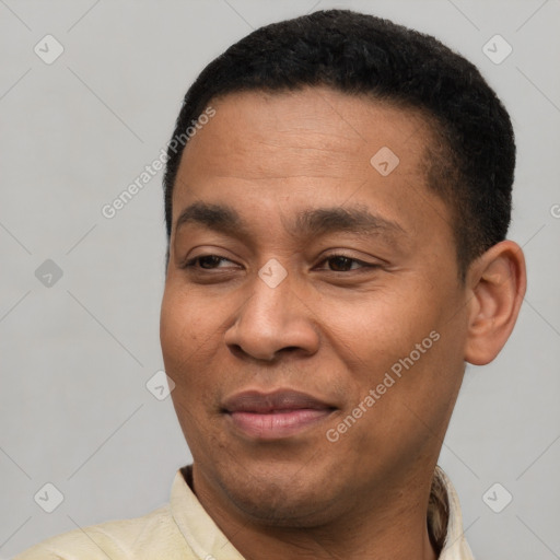 Joyful latino adult male with short  brown hair and brown eyes