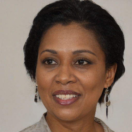 Joyful black adult female with medium  brown hair and brown eyes