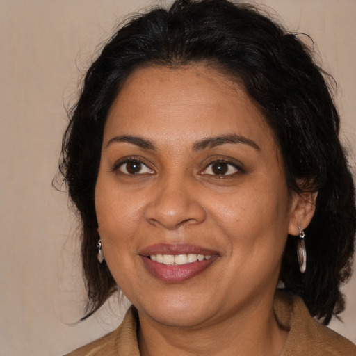Joyful white adult female with medium  brown hair and brown eyes