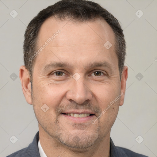 Joyful white adult male with short  brown hair and brown eyes