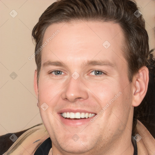 Joyful white adult male with short  brown hair and brown eyes