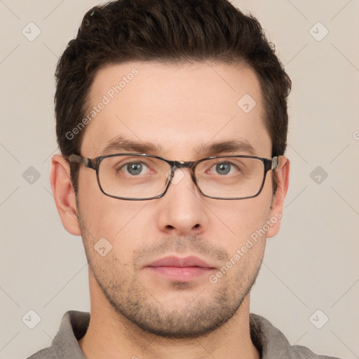 Joyful white young-adult male with short  brown hair and grey eyes