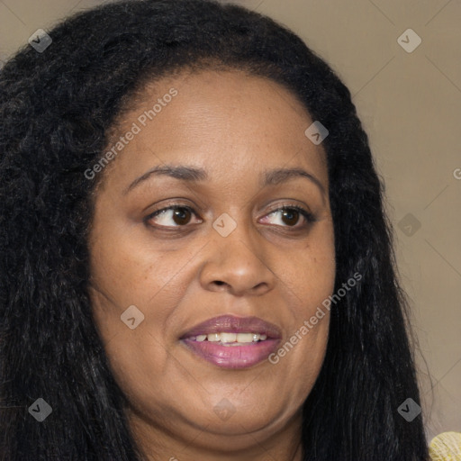 Joyful black adult female with long  brown hair and brown eyes