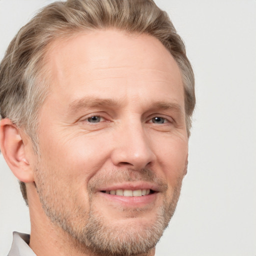 Joyful white adult male with short  brown hair and grey eyes