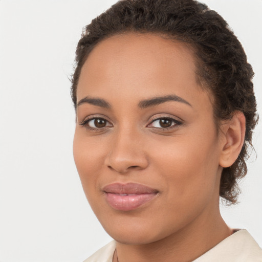 Joyful latino young-adult female with short  brown hair and brown eyes