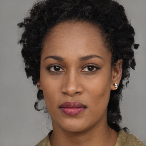 Neutral black young-adult female with long  brown hair and brown eyes