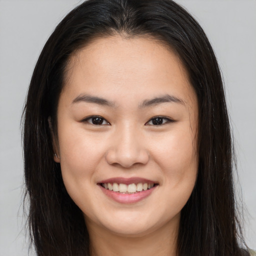 Joyful asian young-adult female with long  brown hair and brown eyes