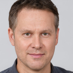 Joyful white adult male with short  brown hair and grey eyes