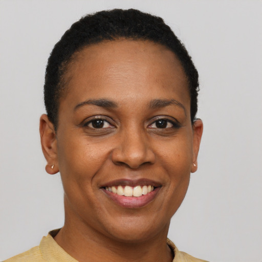 Joyful black young-adult female with short  brown hair and brown eyes