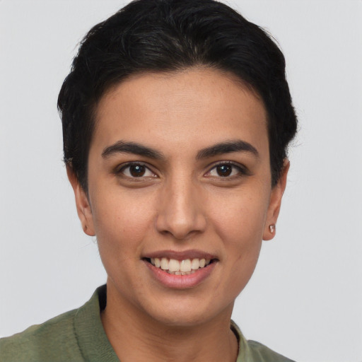 Joyful latino young-adult female with short  brown hair and brown eyes